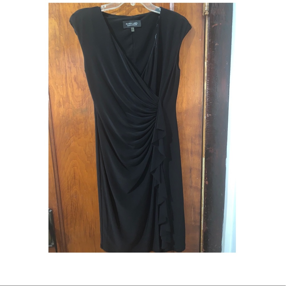Black patted shoulder dress .